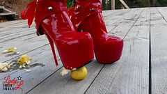 Lady L crush apples with extreme sexy red boots. Thumb